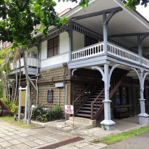Philippines: a historic building with a stone lower section and wooden upper section.