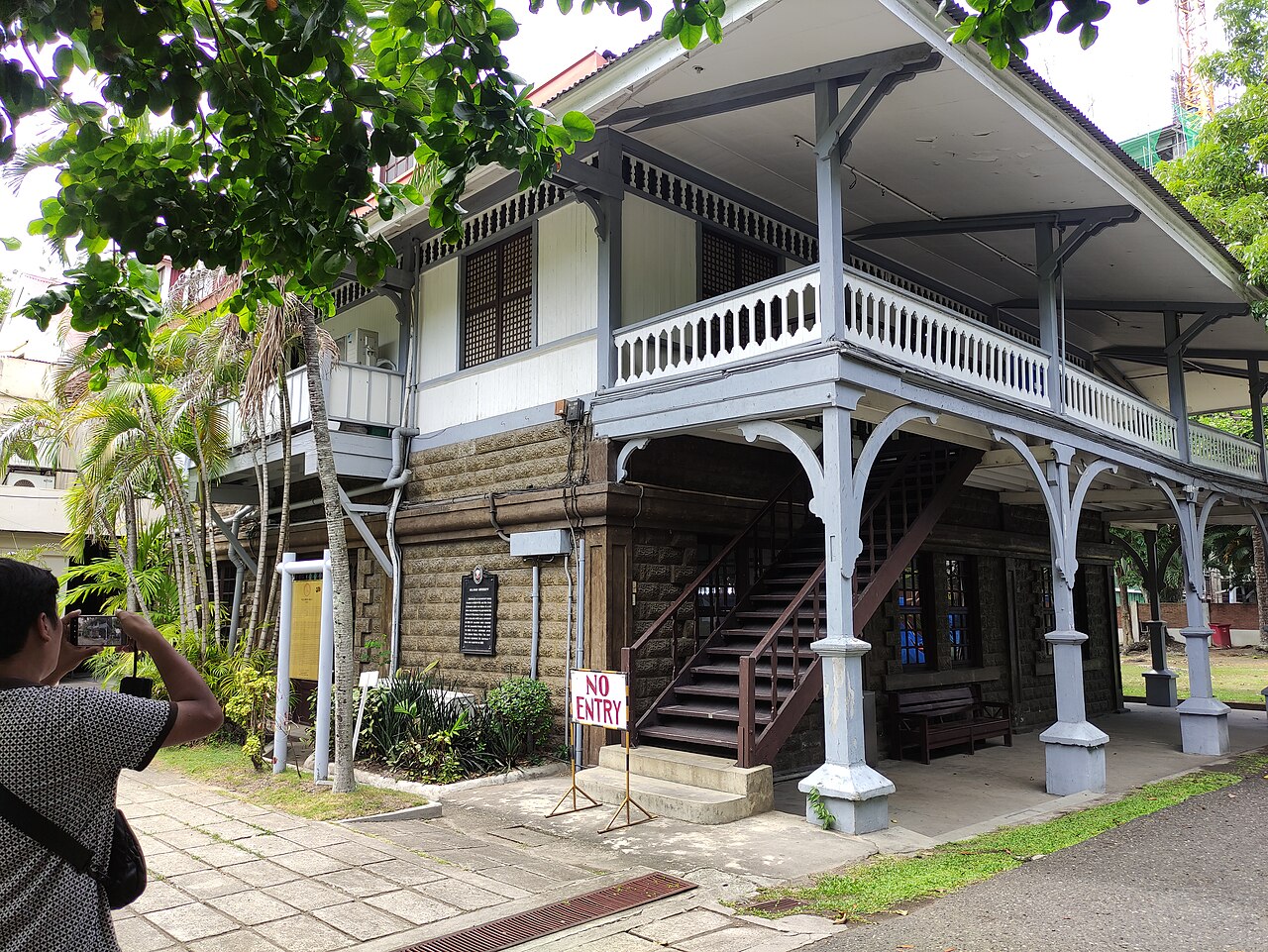 Philippines: a historic building with a stone lower section and wooden upper section.